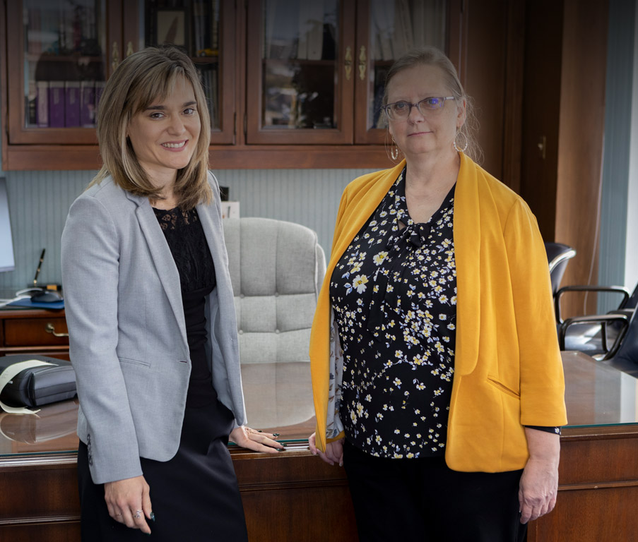 janet and jolan standing in Larson's office